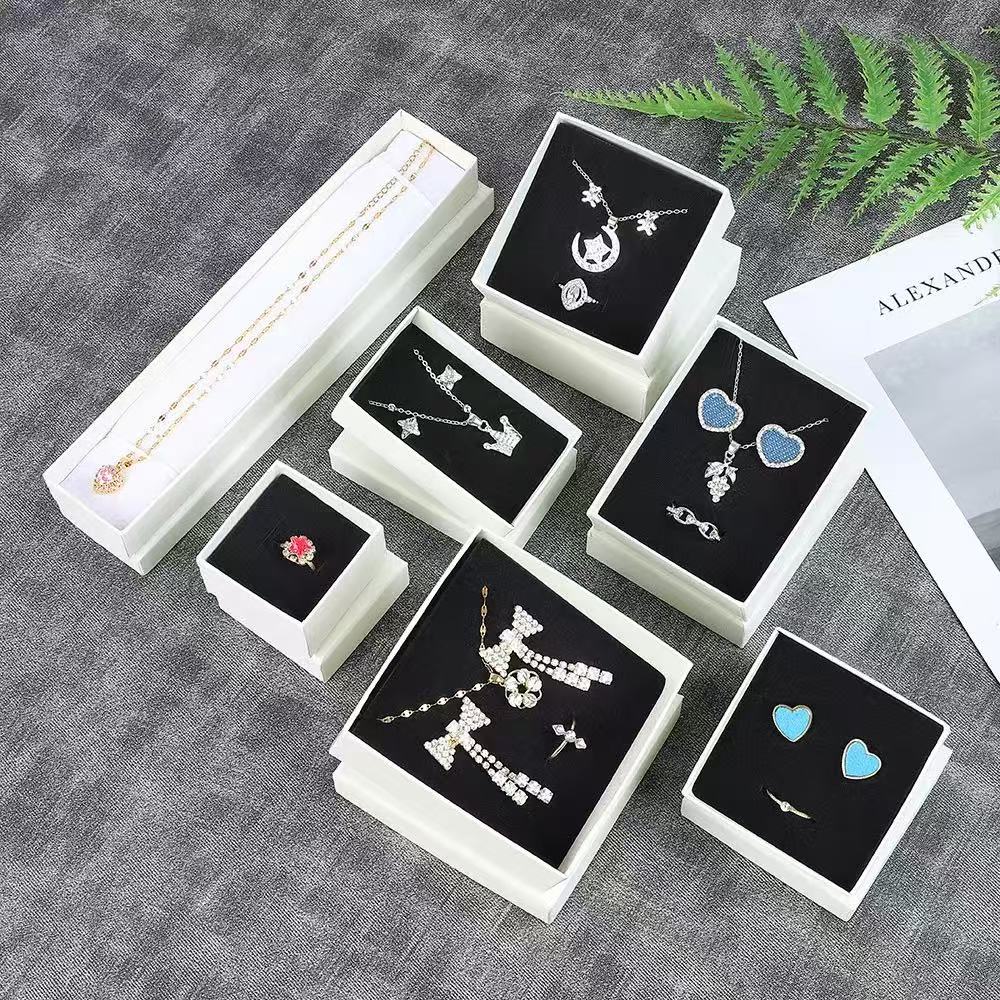 White lift-off lid gift box holding a ring and necklace